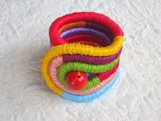 a stack of colorful bracelets sitting on top of a white table