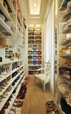 a woman standing in front of a closet filled with shoes