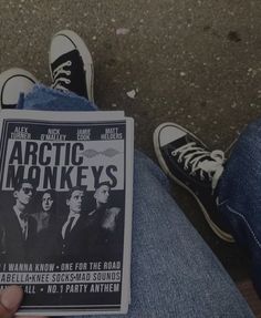 someone is holding up a book about arctic monkeys