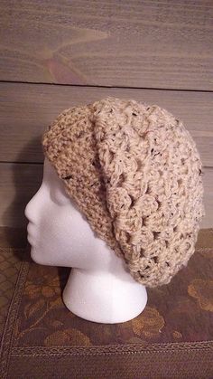 a crocheted hat on top of a mannequin head