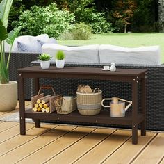 a coffee table on a deck with some plants and other things in front of it