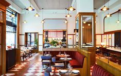 a restaurant with checkered flooring and wooden booths