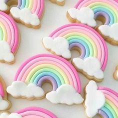 cookies decorated with rainbows and clouds on a table