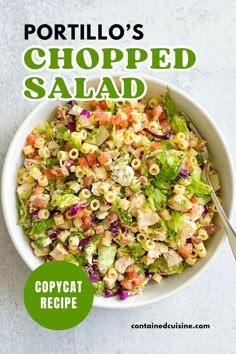 a white bowl filled with salad next to a spoon