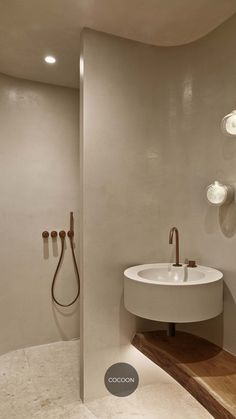 a bathroom with a sink, shower and mirror on the wall next to each other