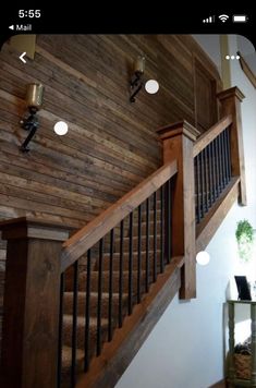 a wooden stair case next to a white wall