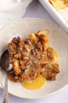 a close up of a plate of food on a table with a fork and spoon