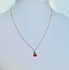 "A beautiful 14K solid yellow gold Red Cherry puffy charm / pendant with hand painted and baked enamel. It has a soldered ring to attach to a bracelet or a necklace. The small pendant measures 10mm (0.39\") tall with bail and without the soldered ring and 7.3mm (0.29\") wide. It can be used as a necklace pendant or a bracelet charm and would make a perfect gift. The pendant can be paired with a shiny 14K Yellow Gold 1.2mm cable link chain in either 16\" or 18\" length or with a 16\" 14K gold-pla Dainty Handmade Enamel Jewelry, Handmade Yellow Gold Charms For Gifts, Handmade Dainty Enamel Jewelry, Dainty Enamel Jewelry Gift, Small Red Jewelry Perfect For Gifting, Small Red Jewelry For Gift, Dainty Adjustable Enamel Jewelry, Dainty Tiny Red Jewelry, Dainty Enamel Nickel-free Jewelry