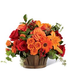 a basket filled with orange and red flowers