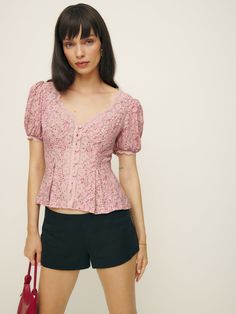 Up top. Shop the Minette Top from Reformation, a fitted top with a v-neckline, button front, short puffed sleeves, and lace detailing. Feminine Fitted V-neck Puff Sleeve Top, Feminine V-neck Tops With Button Closure, Feminine V-neck Top With Button Closure, Feminine Fitted V-neck Blouse, Fitted V-neck Puff Sleeve Top, Spring Fitted V-neck Puff Sleeve Top, Fitted V-neck Puff Sleeve Top For Spring, Feminine V-neck Fitted Puff Sleeve Top, Fitted Feminine Puff Sleeve V-neck Top