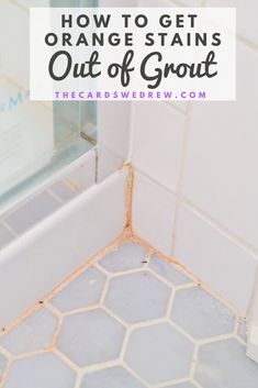 an orange stain on the floor in a bathroom with text overlay that reads how to get orange stains out of grout