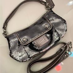 Coach Poppy Limited Edition Silver Sequin Groovy Crossbody Bag #15381 - Style: Crossbody/Satchel - Material: Graphite Grey Silver Sequins With Leather Trim Silver Hardware - Closure: Zip-Top - Inside Zip And Multifunction Pockets - Exterior Front Pocket Kept Closed With Hidden Magnetic Snap - Fabric Lining. - Approx. 11" (L) X 6.75" (H) X 4" (W) - 100% Authentic New Without Tags Luxury Coach Bag For Party, Luxury Coach Party Bag, Luxury Coach Party Bags, Chic Coach Party Bag, Chic Party Bags By Coach, Elegant Coach Shoulder Bag For Party, Crossbody Satchel, Coach Poppy, Silver Sequin