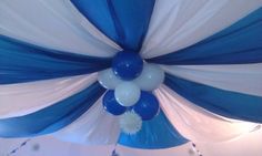 the ceiling is decorated with blue and white balloons