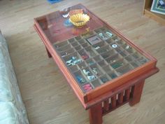 a coffee table with glass top and drawers on it