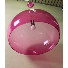 a pink light fixture hanging from the ceiling