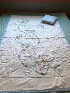 a bed with a quilt on top of it