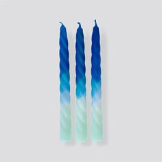 two blue candles sitting next to each other