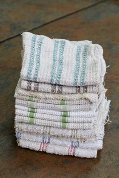 stack of folded towels sitting on top of a wooden table