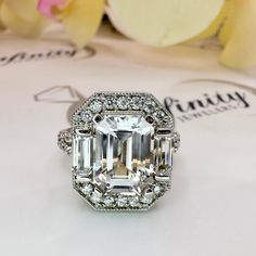 an emerald cut diamond surrounded by diamonds