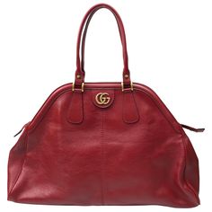 Gucci Red Marmont Re(Belle) Handbag. This beautiful Gucci handbag is in excellent condition. It has no sign of use and has the care card with a color swatch in the pocket. It is a large bag with a deep red leather material. There is gold hardware with a gold "GG" on one side and a gold Tiger head on the other side. It has a gold zipper going across the top with two top handles. This piece is the perfect addition to any summer outfit and has plenty of room on the inside for storage of items. Meas Chic Gucci Satchel With Removable Pouch, Everyday Handheld Gucci Satchel, Chic Handheld Gucci Bag, Chic Gucci Handheld Shoulder Bag, Chic Handheld Gucci Shoulder Bag, Gucci Formal Satchel With Removable Pouch, Gucci Satchel With Removable Pouch For Formal Occasions, Gucci Formal Satchel Bag, Gucci Formal Bags With Double Handle