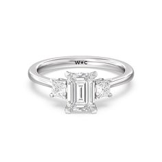 an emerald cut diamond ring with three side stones