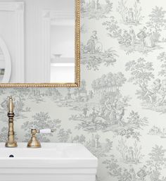 a bathroom sink sitting under a mirror next to a wallpaper covered in white and gold