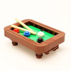 a toy foo - o - ball table with two baseball bats and three balls in it