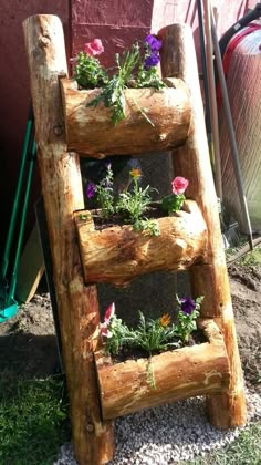 a wooden ladder with flowers growing in it