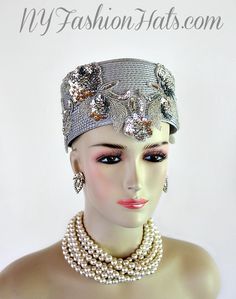 Women's Silver Grey Metallic Silver Pillbox Fashion Designer Haute Couture Hat Headpiece. Metallic Silver Glass Beaded Sequin Pearl Floral Appliques Are Placed On This 1920's Flapper And Art Deco Era Hat. This Formal Hat Can Be Worn In Different Positions. This ladies bespoke formal hat is appropriate to wear for the Kentucky Derby, Melbourne Cup, Royal Ascot, horse races, horse racing, Church, weddings, and special occasion. This lovely hat is also suited for mother of the bride or a bride. This Unique Hat Will Make A Fashion Statement. This Special Occasion Hat Is Custom Made And Designed By NY Fashion Hats Millinery, www.nyfashionhats.com, Dress Hats For Women, www.dresshatsforwomen.com

Measurements: Crown Measures 22.5". Standard Sized For Most Women - Condition New - Custom Made

Mat Bridesmaid Headpiece, Special Occasion Hats, Mother Of The Bride Hats, Braided Dress, Formal Hat, Bespoke Hats, Bridal Art, Preakness Stakes, 1920's Flapper