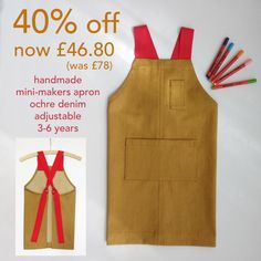 the apron is made from an old piece of cloth and has red suspenders on it