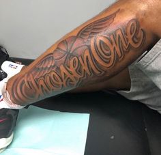 a man with a tattoo on his arm that says awesome one in large letters and an eagle