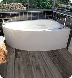 a white bath tub sitting on top of a wooden floor