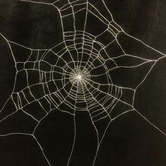 a spider's web on a black background with light coming from the center and bottom