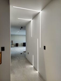 an empty room with white walls and lights