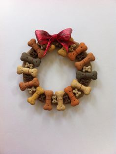 a wreath made out of dog treats with a red bow