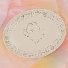 a white plate with a drawing of a flower on the side and hearts around it