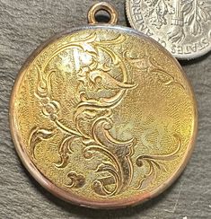 "Gorgeous Gold filled antique round Locket with a floral motif-never was monogramed.  Condition closes, good hinge, inside looks almost new even though it's probably 100 years old-photos show the details.  size 1 1/8\" in diameter, wt.- 7.9 grams.  What a lovely way to keep and show much loved photos." Round Locket, Locket Necklace, Floral Motif, 100 Years, Old Photos, Locket, Gold Filled, Floral Design, Jewelry Necklaces