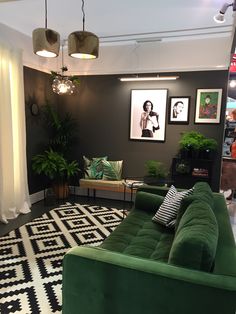 a green couch sitting on top of a black and white rug