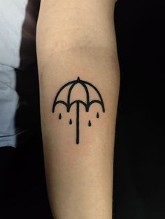 a person with a tattoo on their arm holding an umbrella