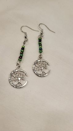 The dangle earrings feature a row of green and metallic colored glass beads (3mm) with a silver tree of life charm with clear rhinestones at the end. The earrings are just under 2" long, the drop is total of 2 1/2". Handcrafted Ornaments, Silver Tree, Bead Earrings, Green Bead, Clear Rhinestones, Wire Wrapped Jewelry, Resin Art, Earring Necklace, Tree Of Life