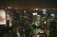 the city lights shine brightly at night in this view from top of the empire building