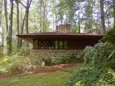 a house in the woods surrounded by trees