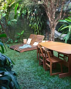 a wooden table sitting on top of a lush green field