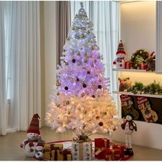 a white christmas tree in a living room