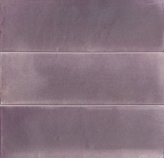 a close up of a purple tile wall with no grouting or stains on it