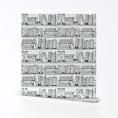 a black and white book shelf with books on it's sides, all lined up in rows