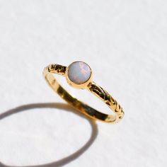 Dainty Gold Opal Ring set with a Natural Australian Opal in a precious grade with natural play of color, at 5mm diameter, 0.6 Carats, sourced from Australia. Made of Gold Vermeil ☞ thickest 18k Gold Plating on top of Solid 925 Sterling Silver ☞ made to last. Other Gemstones Available: Emerald: www.etsy.com/uk/listing/960937363 Aquamarine: www.etsy.com/uk/listing/1019561550 Garnet: www.etsy.com/uk/listing/1005113644 Natural Ruby: www.etsy.com/uk/listing/1036502635 ☞ Choose your size ☞ I resize (b Bohemian 14k Gold Round Rings, Spiritual Wedding Jewelry With Bezel Setting, Bohemian Stackable Round Rings For Weddings, Heirloom Style Wedding Midi Rings, Delicate Rings With Intricate Design, Heirloom Opal Jewelry In Round Shape, Bohemian Birthstone Jewelry For Wedding, Heirloom Opal Jewelry, Dainty Handmade Opal Ring For Wedding