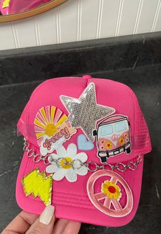 Perfect summer hat for any occasion. These patches were hand picked to put together this super fun and eye catching trucker hat. It features an adjustable snap back for a perfect fit. Hat patches may vary slightly depending on availability but is guaranteed to be eye-catching. Trendy Pink Hats For Music Festival, Fun Pink Hat For Music Festival, Cute Festival Trucker Hat, Trendy Adjustable Costume Hats And Headpieces For Festival, Trendy Festival Mini Cap Hats, Trendy Mini Hats For Festivals, Trendy Mini Cap Hats For Festivals, Funky Snapback Hat For Festivals, Fun Flat Brim Hats For Festivals