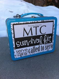 a blue and white suitcase sitting on top of snow covered ground