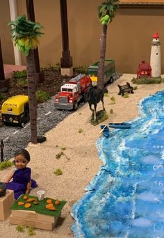 a child is playing with toys in the sand at a toy beach and water park